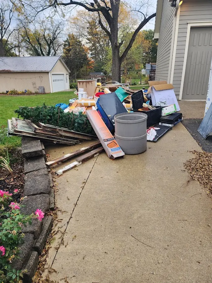 Dumpster being loaded with debris for Estate Cleanout Dumpster Rental in Batesville